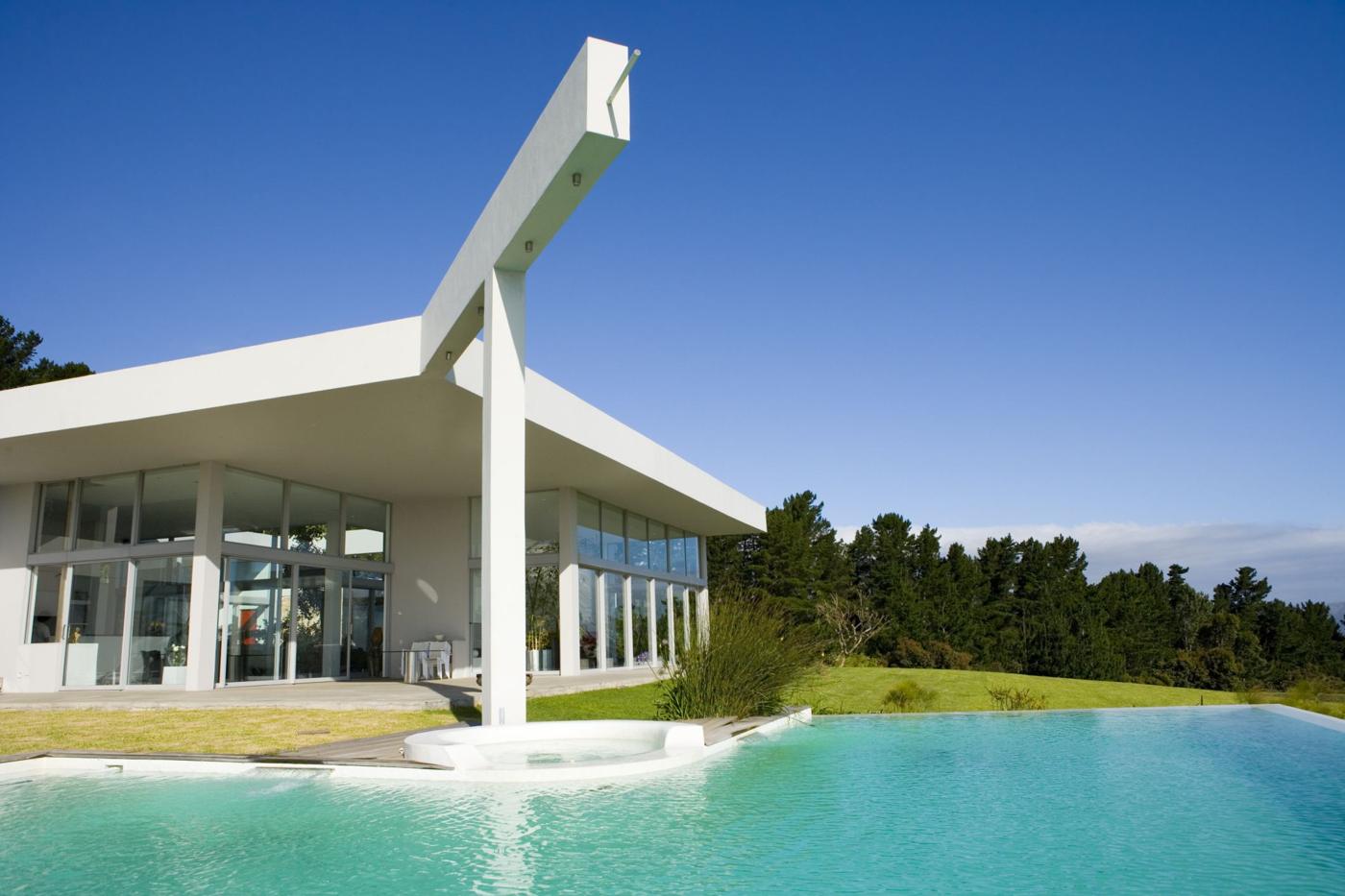 A modern white home with a pool